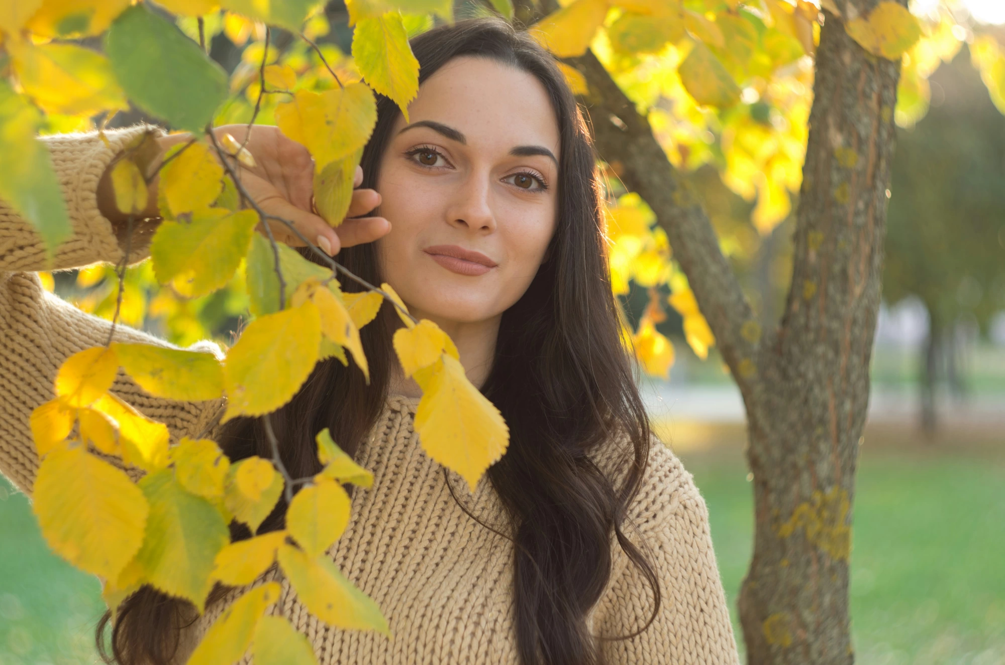 Woman with autumn leaves illustrating fall skincare and dry skin
